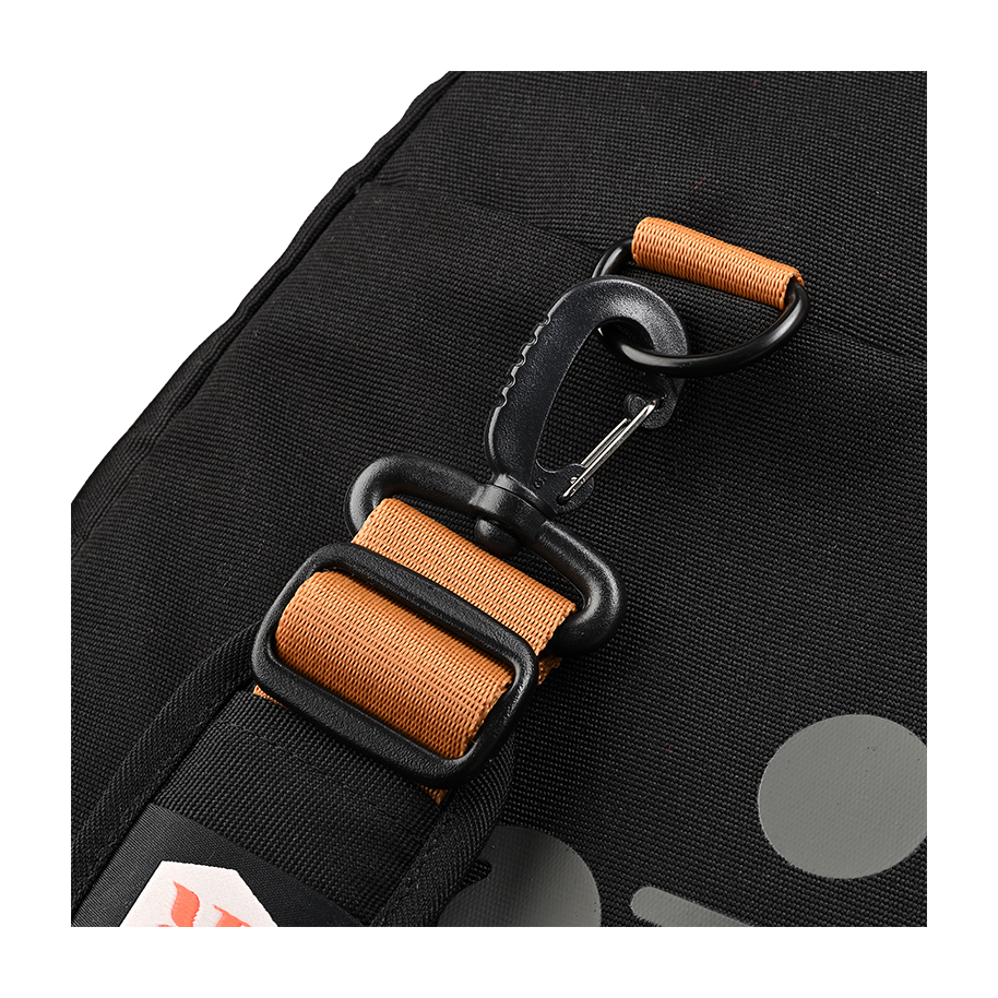 Ritual Calibre hockey duffle bag black with an orange strap and carabiner, close up view
