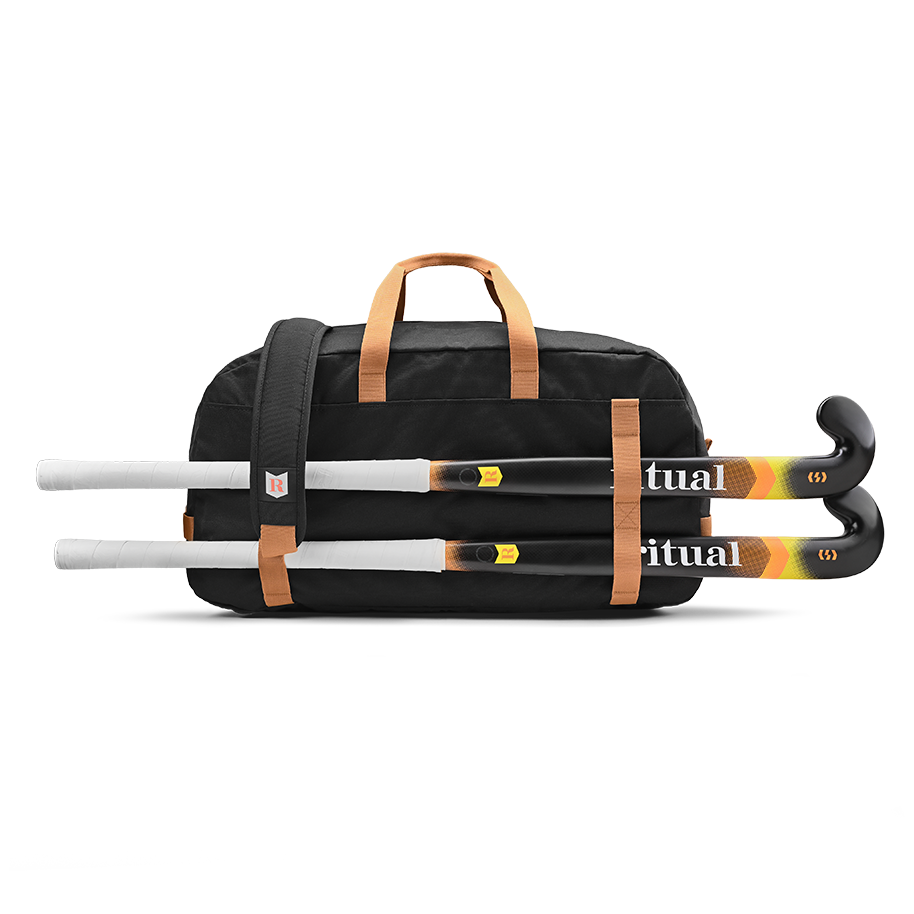 Ritual Calibre hockey duffle bag black with brown straps holding three field hockey sticks