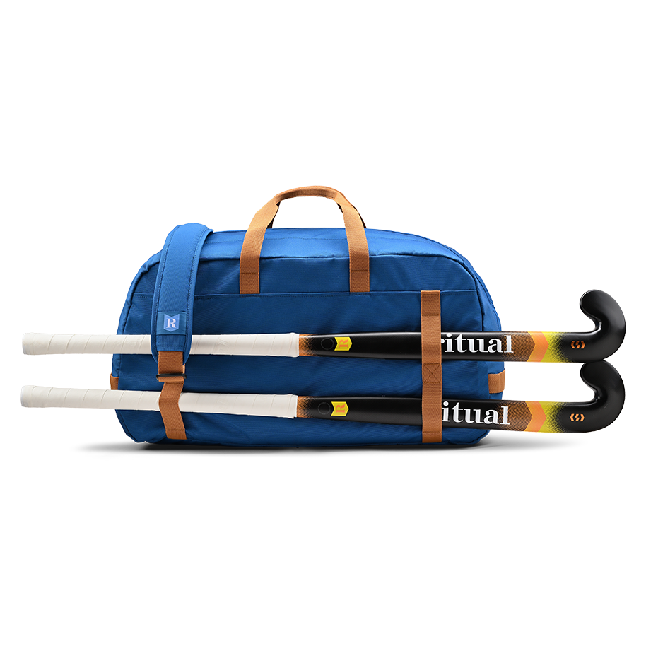Ritual Calibre hockey duffle bag blue holding three field hockey sticks 