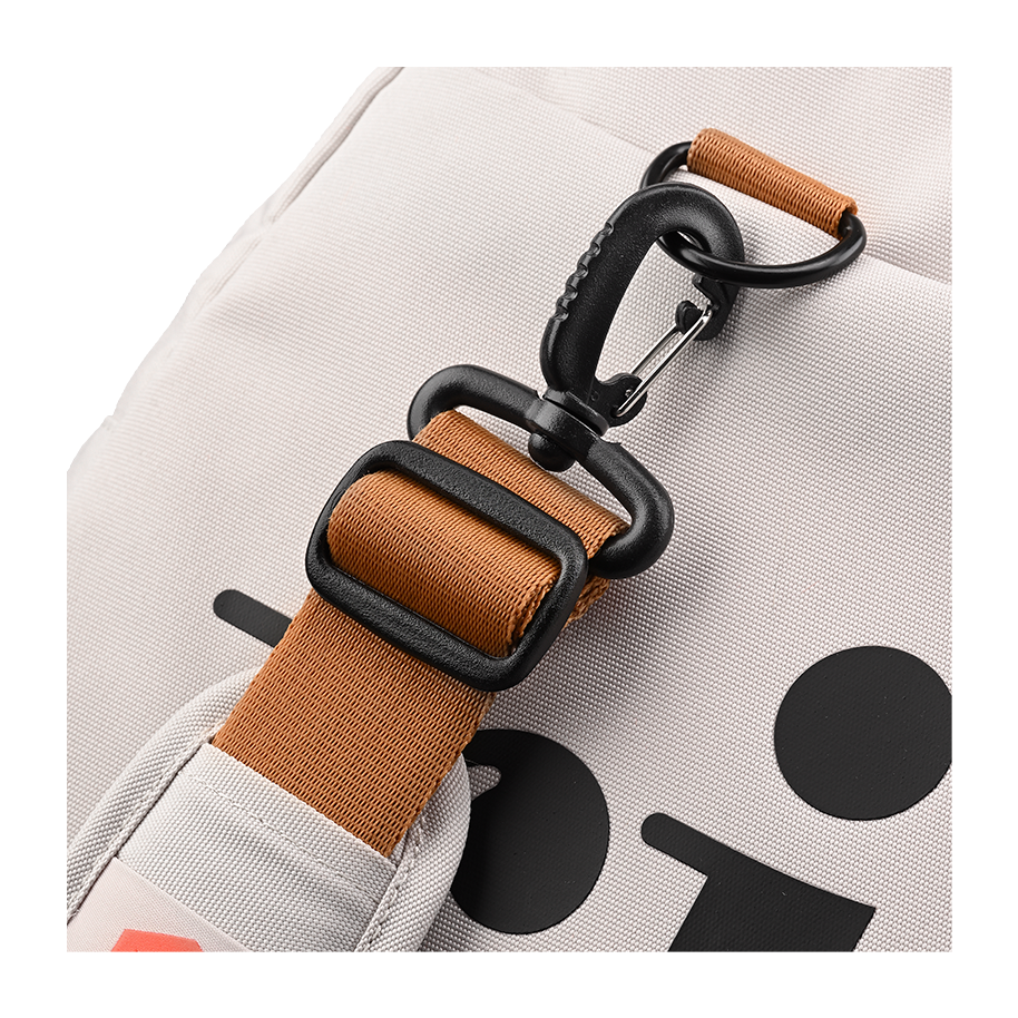 Ritual Calibre hockey duffle bag white side with brown strap and black carabiner, closeup view