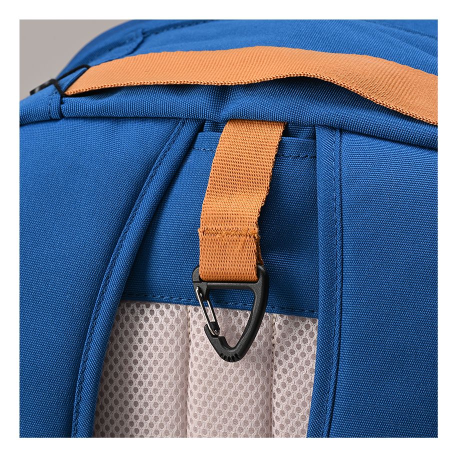 Ritual Covert hockey backpack blue with an orange strap and black carabiner, closeup view