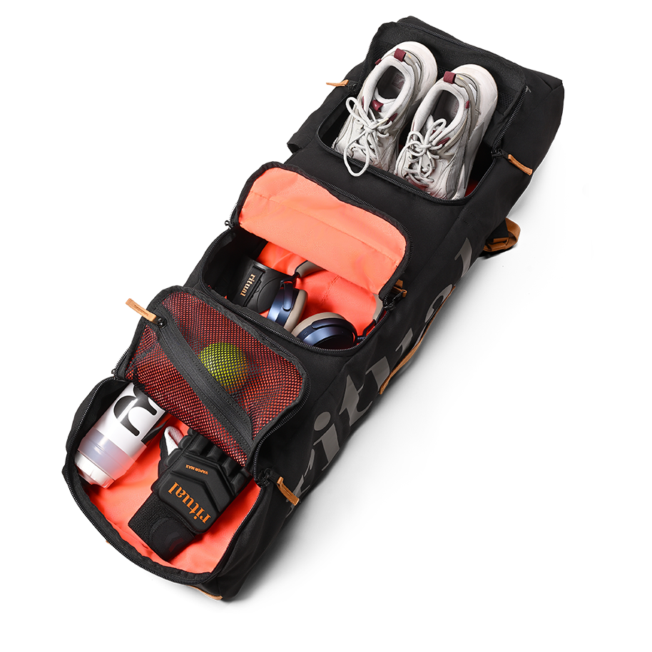 Ritual Mission combo hockey bag black with orange interior, containing shoes, a bottle, and other items , inside view